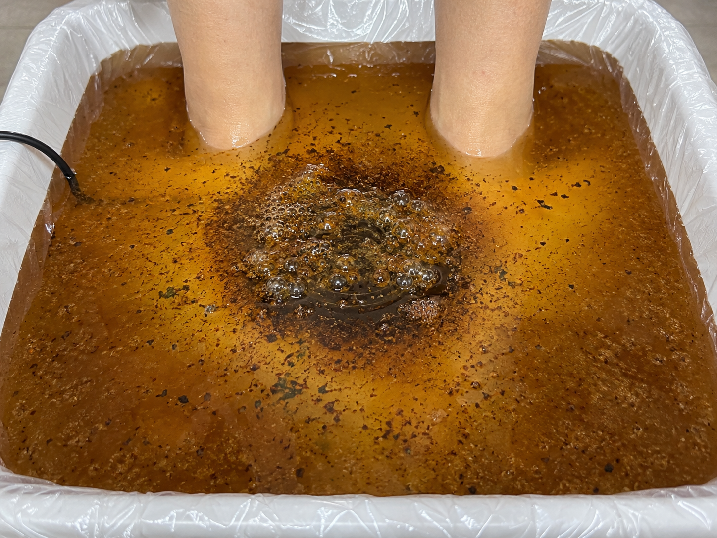 Foot bath with amber-coloured water