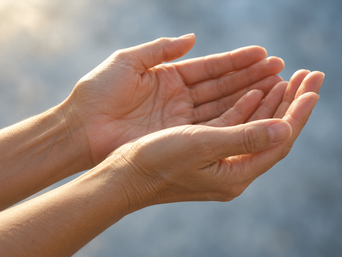 Close-up of relaxed hands in warm natural light